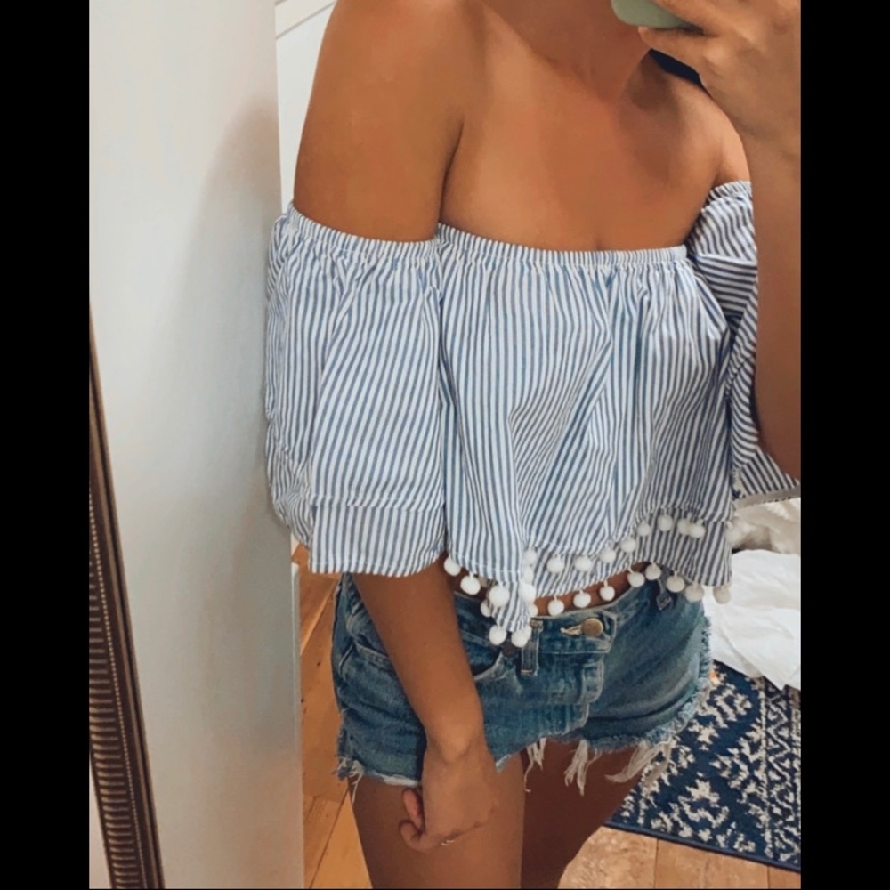 Blue and white strapless top with pom poms